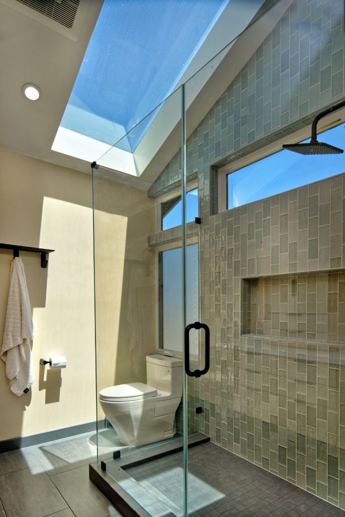 bathroom remodel with sun light above shower